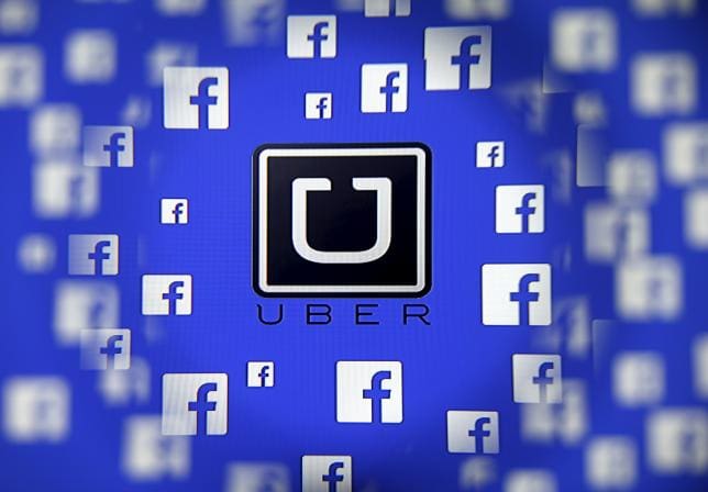 Logo of the Uber and Facebook are seen through magnifier on display in this illustration taken in Sarajevo